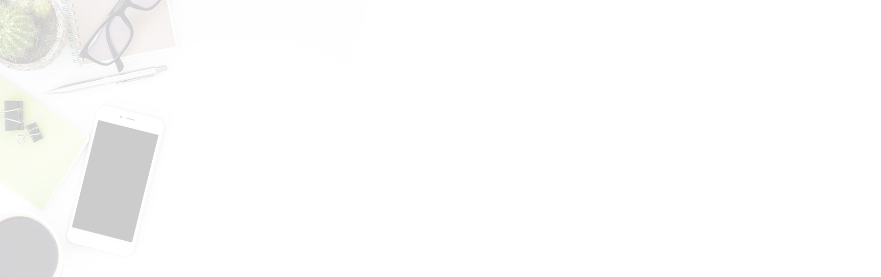 Wooden table with a glass of water, coffee cup, and a notebook with a pen.